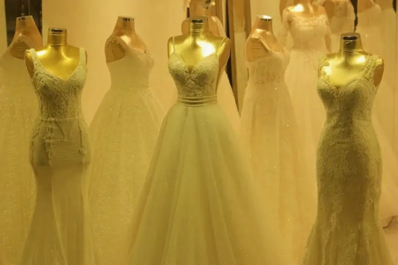 wedding dresses in different silhouettes displayed in a bridal salon, wedding dress silhouette guide